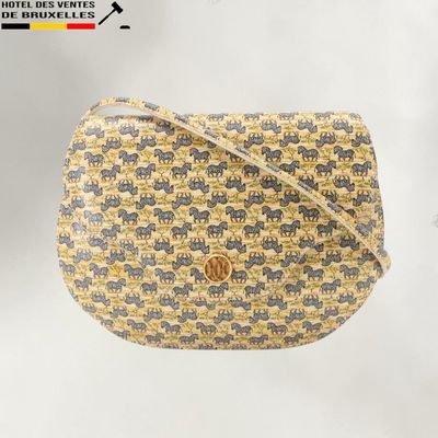 une image représentant un sac à main orné d'un motif d'éléphants