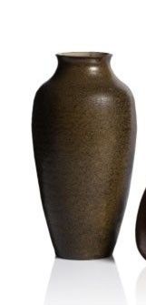 two vases sitting next to each other on a white surface