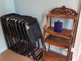 many chairs and a shelf in the corner of a room