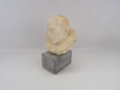 sculpture of a woman ' s head on a marble block