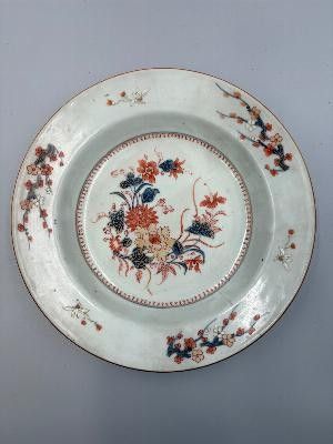 a plate with a floral design on it on a table