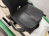 a black seat on the back of a green scooter