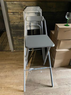a stack of boxes and a chair in a room