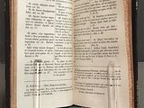 a book open on a table with two candles on it
