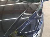 a close up of a car ' s hood with a sticker on it