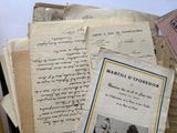 a pile of old letters and papers sitting on a table