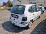 a small white car parked in front of a building