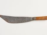 an old knife with a wooden handle on a white surface