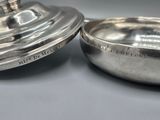 pair of silverplated dishes with lids on a gray surface