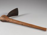 an old axe with a wooden handle sitting on top of a table