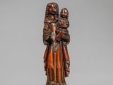 une statue en bois représentant une femme tenant un enfant