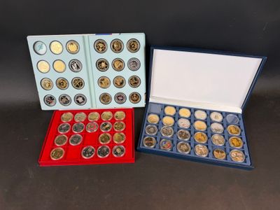two boxes of coins are sitting next to each other on a table