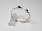 a close up of a ring on a white surface with a tube