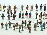 a lot of figurines that are on a white surface