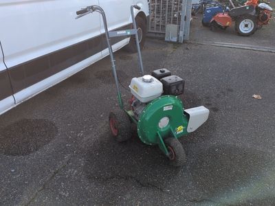 a lawn mower that is sitting on the street