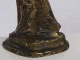 bronze figurine of a woman holding a baby in her arms