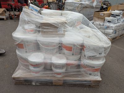 a pallet full of buckets of food sitting on a pallet