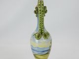 a small vase with a cactus on the top of it