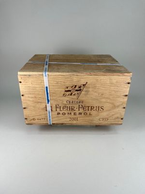 an old wooden box with a label on it sitting on a table