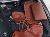 a bag, purse, and other items in the trunk of a car