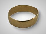 a close up of a gold ring on a white surface