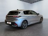 the rear end of a silver car in a showroom