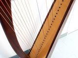 a close up of a large harp on a stand