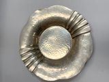 a silver plate with a flower design on it