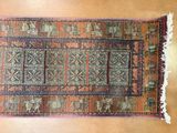 a rug on a wooden floor with a brown background