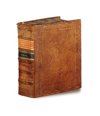 an old book sitting on top of a white surface