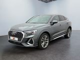 a grey audi qx parked in a showroom