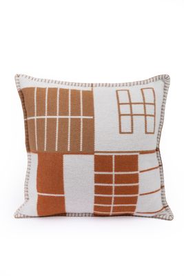 a brown and white pillow with squares on it