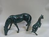 two figurines of a horse and a dog on a table
