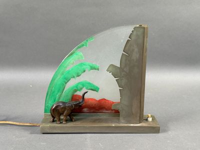 a figurine of an elephant and a palm tree on a bookend
