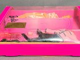 pink box with a pink and black cat in it on a table