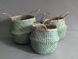 two green and white baskets sitting on top of a table