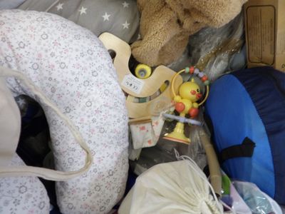 a teddy bear that is sitting in a pile of toys