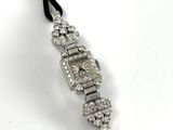 a close up of a watch on a black cord with diamonds