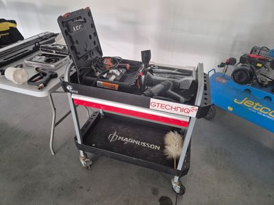 a small cart with tools on it in a garage