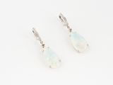a pair of white oplite earrings on a white background