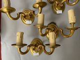 a wall mounted candle holder that has five candles on it