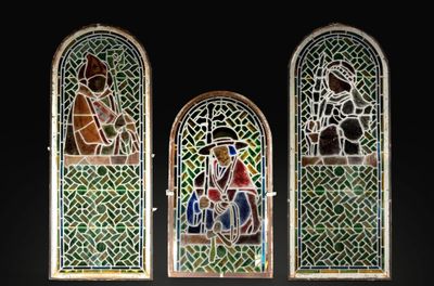 three stained glass windows in a dark room with a black background