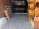 a van that is parked inside of a building with boxes in the back