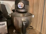 a silver mixer on a wooden shelf next to a blender