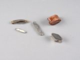 four different types of metal objects on a white surface