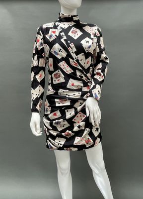 a mannequin wearing a black and white dress with playing cards on it