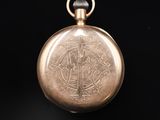 an antique pocket watch on a black background with a black background