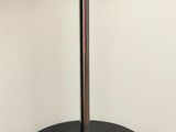 a black table with a silver lamp on top of it