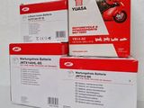 three boxes of red and white batteries sitting on top of each other