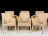 four wicker chairs are arranged in a row on a white surface